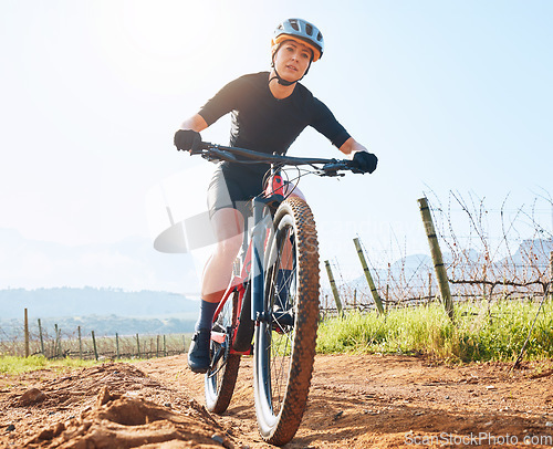Image of Portrait, fitness and woman with a bicycle, outdoor and training for wellness, competition and workout. Face, female athlete or biker cycling, adventure and practice for marathon and countryside trip