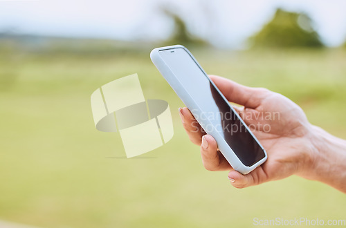 Image of Hand, phone and person use gps online on mobile app to navigate on a field with internet connection for a smartphone. Cellphone, mockup and closeup of web search on a website outdoors in nature