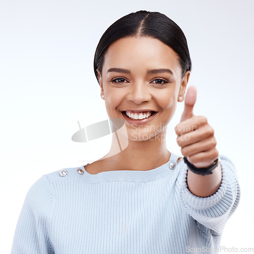 Image of Portrait, thumbs up and motivation with a woman on a white background in studio for feedback or success. Winner, emoji or hand gesture with an attractive young female saying thank you to show support