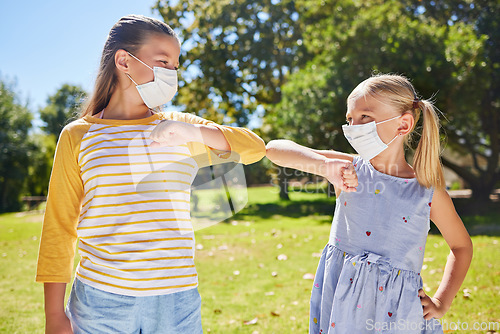 Image of Elbow greeting, covid and kids outdoor together for social distance, prevention or safety. Girls, park and friends bump elbows with children in face mask for hello and solidarity at school in summer