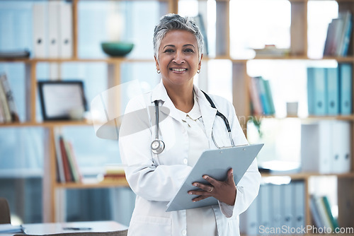 Image of Senior woman doctor, portrait and checklist in clinic for inspection, healthcare paperwork or report. Female medic, clipboard and documents for results, analysis or diagnosis with smile at hospital