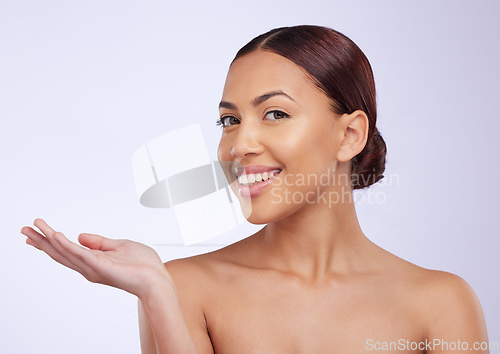 Image of Woman, skincare and portrait with open hand for mockup space, beauty or product placement with smile on face. Girl, model and facial skin wellness for cosmetic, health or mock up by studio background