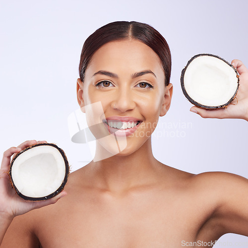 Image of Woman, coconut and studio portrait with smile for self care, skincare or beauty with natural benefits for face. Girl, model and fruit for skin wellness, cosmetic health and dermatology by background