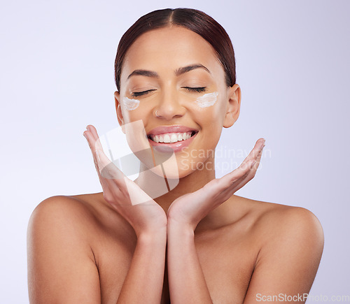 Image of Face cream, beauty and woman in studio for skincare, treatment and dermatology on purple background. Facial, lotion and sunscreen for happy lady model relax with spf, moisturiser or skin routine