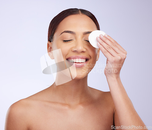 Image of Beauty, skincare and cotton swab with a woman in studio on a gray background for natural treatment. Facial, wellness and anti aging with an attractive young female exfoliating her face or skin