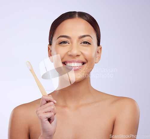 Image of Happy, dental health and portrait of a woman with a toothbrush isolated on a white background in a studio. Smile, grooming and a girl brushing teeth and showing results from a whitening treatment