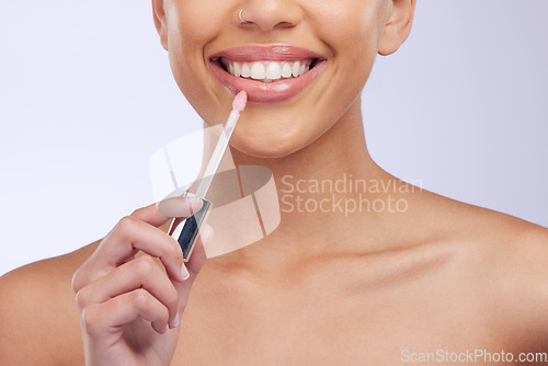 Image of Closeup, smile and woman with skincare, lip gloss and cosmetics isolated on a white studio background. Zoom, female model and person with makeup product, lipstick and happiness with beauty and glow