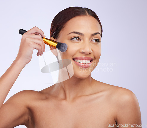 Image of Makeup, beauty or happy woman with foundation brush in studio with facial cosmetics or skincare products. Smile, face grooming application or girl model isolated on white background with mockup space