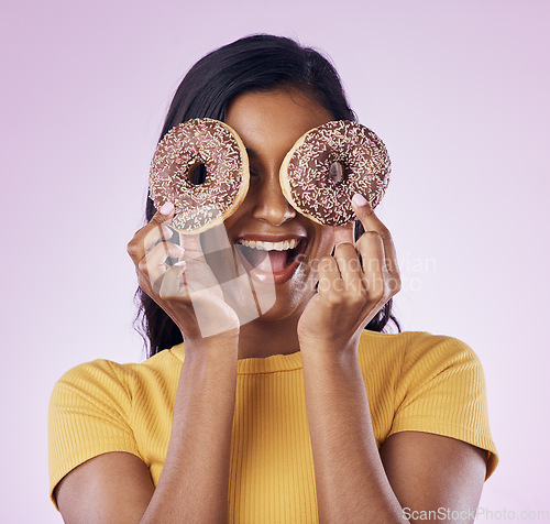 Image of Donut, dessert and cover with woman in studio for diet, snack and happiness. Sugar, food and smile with female hiding and isolated on pink background for nutrition, playful and craving mockup