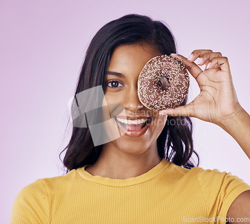 Image of Donut, cover with portrait of woman in studio for diet, snack and happiness. Sugar, food and smile with female hiding and isolated on pink background for nutrition, playful and craving mockup