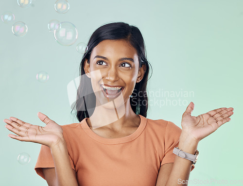 Image of Happy, bubbles and wow with woman in studio for creative, magic and rainbow. Playful, funny and laughing with female and excited and isolated on background for bright, happiness and freedom