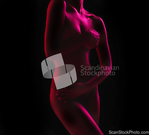 Image of Neon, seductive and the body of a woman in the dark isolated on a black background in a studio. Sexy, art and a girl covering with a purple glow for creativity, mystery and artistic on a backdrop