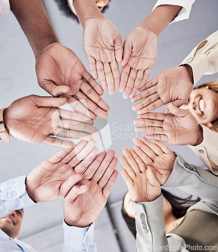 Image of Hands, circle and together in low angle for business people with teamwork, motivation and solidarity in office. Women, happiness and open palm with smile, team building and support for company goals