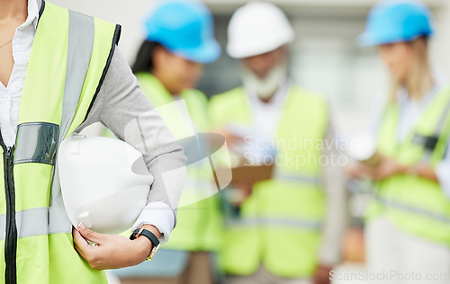 Image of Industry, hardhat and closeup of a woman construction worker with safety equipment or gear. Builder, professional and zoom of a female industrial foreman worker with her building team on a site.