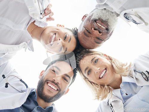 Image of Below portrait, doctors and circle in team building closeup for motivation, success and diversity. Doctor, teamwork and excited face with solidarity, support or collaboration for healthcare in clinic