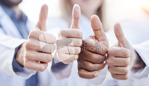 Image of Hands, doctors and thumbs up together in closeup for motivation, agreement and team building in hospital. People, teamwork and hand gesture for diversity, support and trust for healthcare in clinic