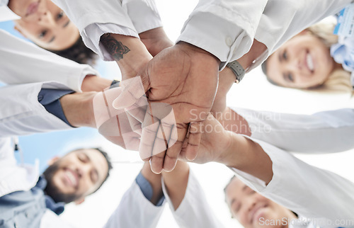 Image of Hand stack, doctors and below group with smile for motivation, success and team building in hospital. People, teamwork and hands together for solidarity, support and goals for healthcare in clinic