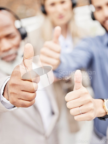 Image of Business people, call center and hands with thumbs up for winning, teamwork or agreement at office. Hand of group consultant or agents showing thumb emoji, yes sign or like for good job or success