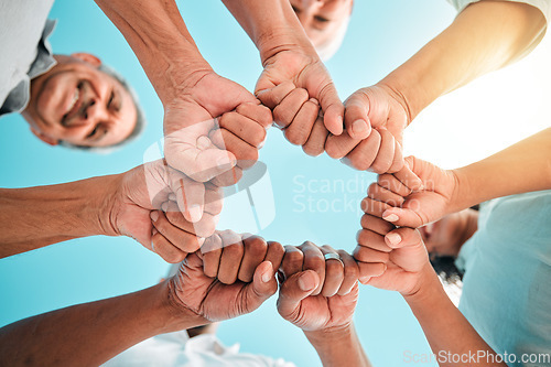 Image of Fist, hands circle and below group of family, men and women for support, motivation or love. People, happy and hand together with solidarity, bonding or outdoor with sky, smile and vacation in summer