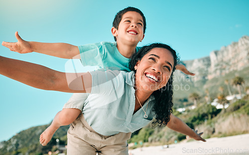 Image of Mother, child and family outdoor at beach playing airplane game for fun. Happy woman and boy kid play and laughing for happiness, freedom and adventure on travel holiday or vacation with love outdoor