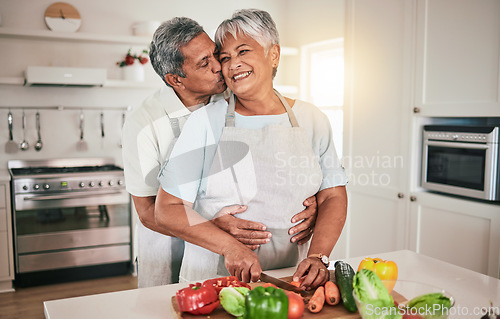 Image of Cooking vegetables, hug and elderly couple with kitchen ingredients, prepare food or smile on romantic home date. Nutritionist, marriage love and hungry man, woman or people bonding over healthy meal