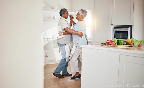 Image of Happy, cooking or elderly couple dance in the kitchen together and feeling love, excited and bonding in home. Care, happiness or romantic old people or lovers dancing and enjoying retirement in house