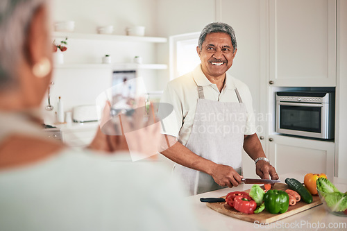 Image of Kitchen cooking, senior couple and phone picture of old man, husband or nutritionist person with memory photo. Vegan, vegetables or people recording web video, smile or cutting lunch food ingredients
