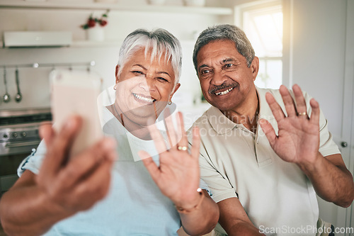 Image of Video call, waving and elderly couple on phone, happy and smile in their home kitchen. Smartphone, love and old people greeting, excited and cheerful for online conversation and enjoying retirement