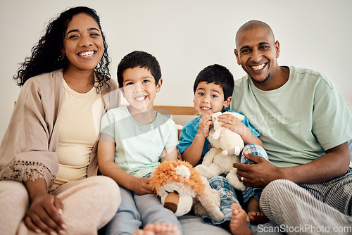 Image of Happy family portrait of mother, father and children with teddy bear, toys and home bonding, playing and enjoying time together. Happiness, morning love and smiling mom, dad and kids relax in bedroom