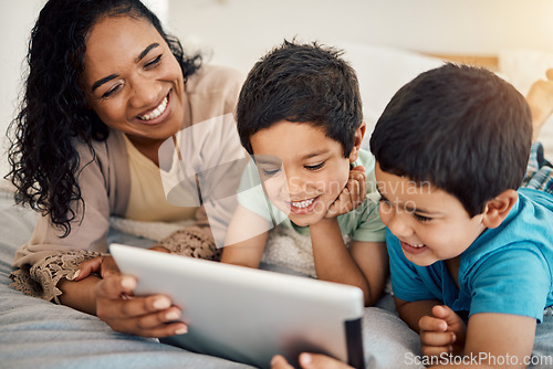 Image of Tablet, education and a woman with her children on a bed at home in the morning together for entertainment. Family, boy or brother with a mother and her kids learning online in the bedroom of a house