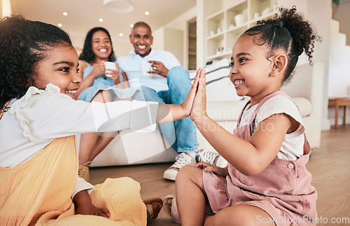 Image of Family, high five and children playing, smile and having fun in a living room. Kids, hands and games with parents bonding in their home, cheerful and relaxing, smiling and enjoying happy childhood