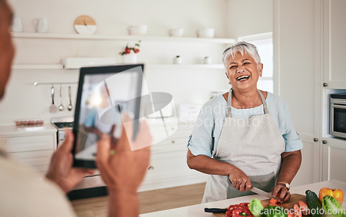 Image of Cooking food, elderly couple and tablet photo of senior woman, wife or person with digital memory picture. Vegetables nutritionist, photography shooting and laughing people bonding in health kitchen