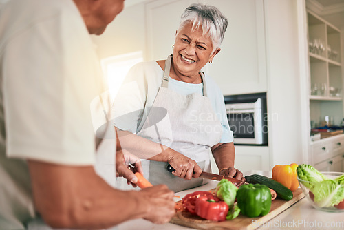 Image of Cooking vegetables, kitchen and senior couple cutting ingredients, prepare food and smile on romantic home date. Health nutritionist, culinary and hungry man, woman or people bonding over lunch meal