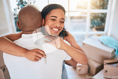 Image of Keys, home and couple hug in apartment excited for moving into new house, property and real estate. Homeowners, love and happy man and woman with key for mortgage, investment and rent in living room