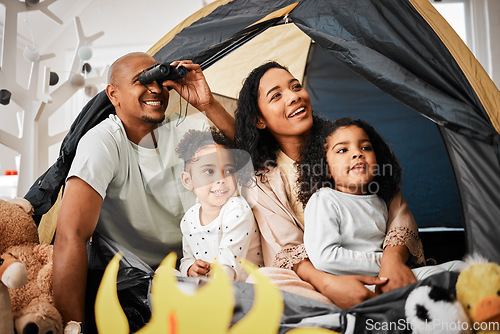 Image of Family, living room and tent with kids, games and toys for bonding, love and playing together. Parents, girl children and looking with mom, dad or camping game in home with happiness on lounge floor