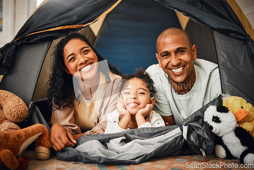 Image of Parents, girl and portrait in tent at house with toys, games and smile with bonding, love and playing together. Mother, father and kid with camping game in family home with happiness on lounge floor