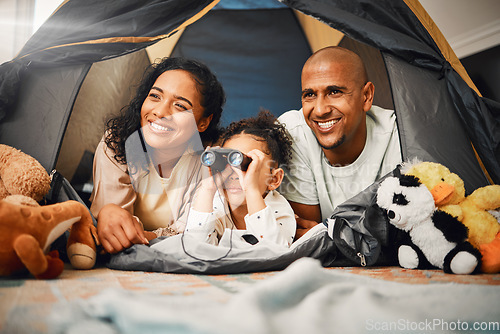 Image of Parents, girl and binoculars in tent, home and smile for games, toys or bonding with love for playing together. Mom, kid and dad with camping game, looking or search in house with happiness on floor