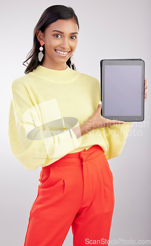 Image of Tablet, mockup and portrait of woman isolated on a white background for fashion e commerce, sale or promotion space. Happy indian person or model with gen z clothes on digital tech mock up in studio