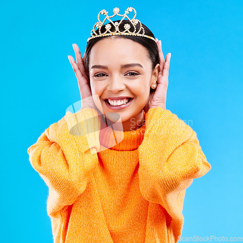 Image of Excited, crown and portrait of woman in studio for celebration, princess and party. Smile, beauty and fashion with female and tiara on blue background for achievement, winner and prom event