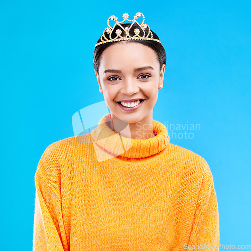 Image of Winner, crown and portrait of woman in studio for celebration, princess and party. Smile, beauty and fashion with female and tiara on blue background excited for achievement, winner and prom event