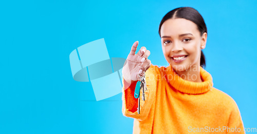 Image of Portrait, mockup and woman with a key, smile and new homeowner against a blue studio background. Face, female person and happy girl with keys, happiness and property owner with success or real estate