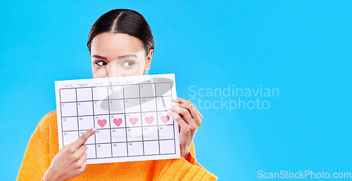 Image of Calendar, period and woman on blue background with heart for schedule, planning and menstruation in studio. Reminder mockup, monthly and eyes of girl with poster for date, weekly planner and cycle