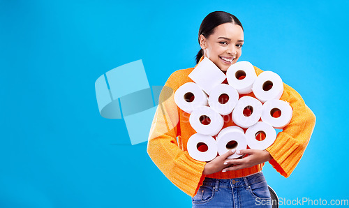 Image of Toilet paper, happiness and woman portrait with mockup and home inventory stock. Isolated, blue background and studio with a young female holding tissue rolls with a happy smile and joy with mock up