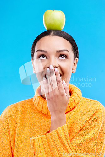 Image of Apple head balance, woman face and surprised with fruit product for weight loss benefits, healthy lifestyle or body detox. Organic food diet, nutritionist studio and shocked person on blue background