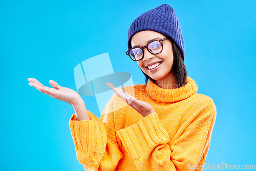 Image of Woman palm, happiness and girl happy in a studio with promotion and announcement. Model, isolated and blue background with mockup of a gen z and cool young female hands show marketing with smile