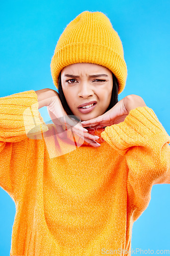 Image of Portrait of woman in winter fashion with confused face, beanie and doubt isolated on blue background. Style, expression and attitude, gen z girl on studio backdrop with warm clothing for cold weather