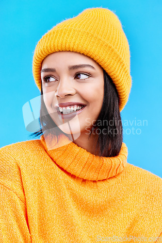 Image of Happiness, excited and woman with youth cap in studio ready for cold weather with winter hat. Isolated, blue background and smiling with a happy young and gen z person with a smile, beanie and joy