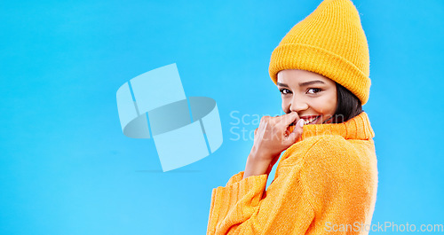 Image of Happiness, excited and woman portrait with mockup in studio ready for cold weather with winter hat. Isolated, blue background and mock up with a happy young and gen z person with a smile and joy