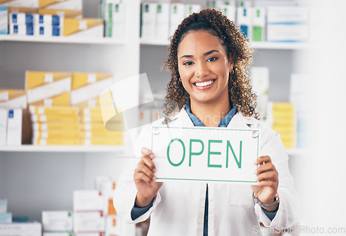 Image of Open sign, medical board and woman portrait in a pharmacy with a billboard. Working, pharmacist poster and healthcare worker with a smile from retail store opening for pill and medicine shop