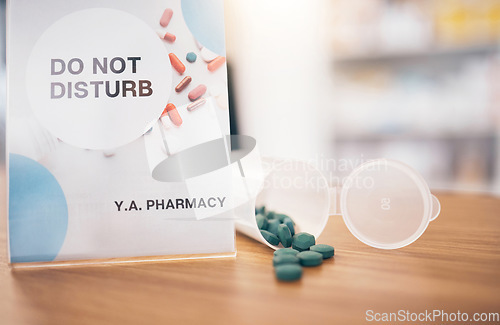 Image of Do not disturb break sign, pharmacy pills and shop poster closeup of an busy board in store. Medical, wellness prescription and medication with a pharmacist placard and billboard on desk at clinic